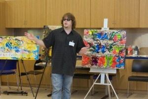 John Bramblitt talking about his works of art to summer campers