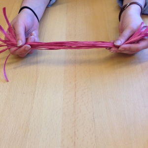  For your basket core, cut the red raffia into ten 24 inch long strands.